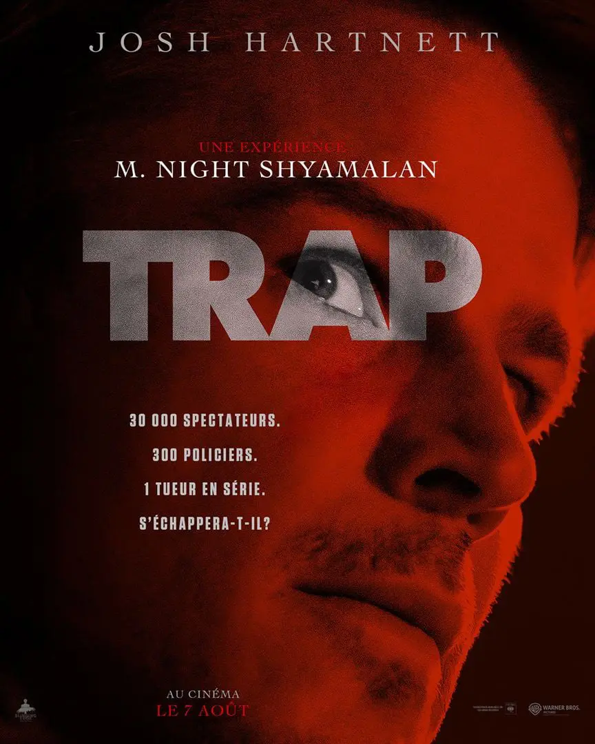 Affiche du film Trap, un gros plan sur le visage de Josh Hartnet qui regarde derrière lui, les couleurs sont rouges.